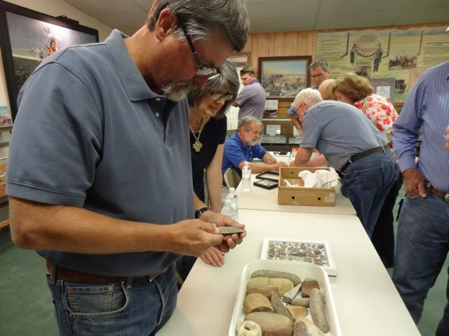 Archaeological expert Paul Katz examining visitor's artifacts